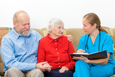 nurse comforting two elder couple