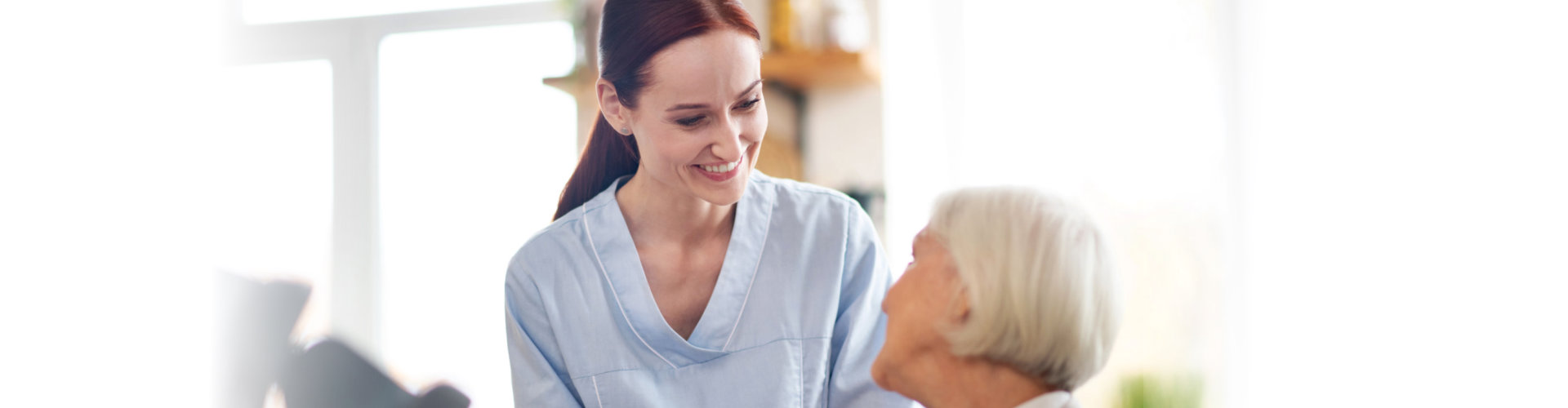 nurse comforting the elder woman